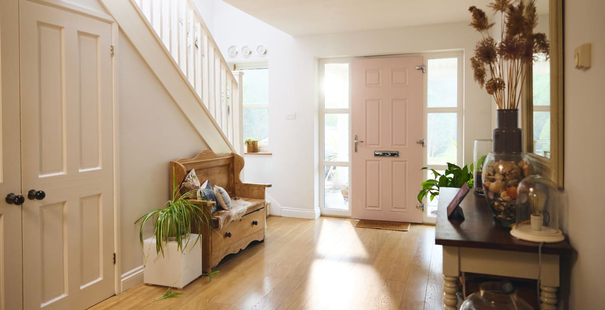 Front and internal doors for Newcastle homes Bright hallway with a pastel front door and white panelled internal doors