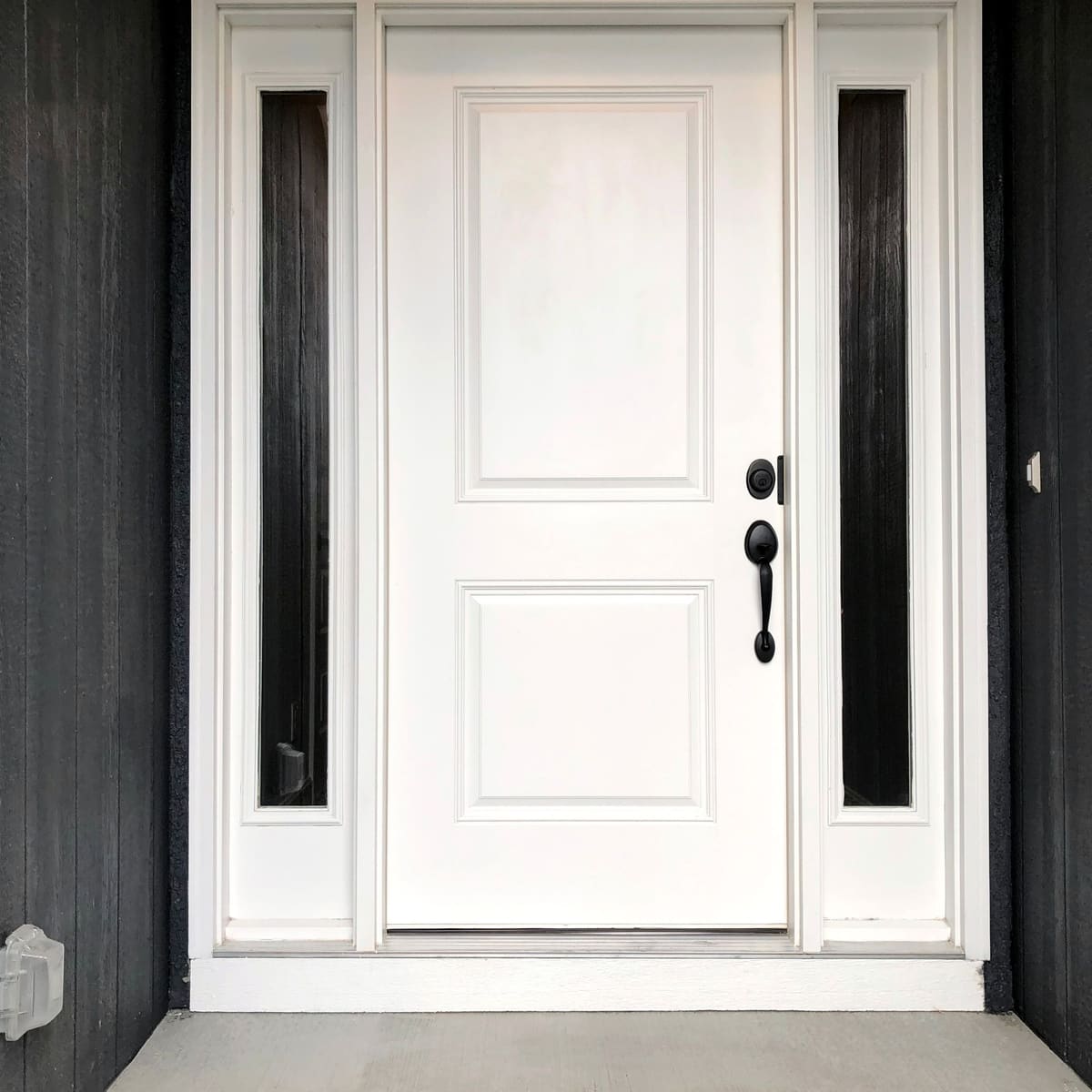 Front door installation in Newcastle White panelled front door with tall glazed side panels